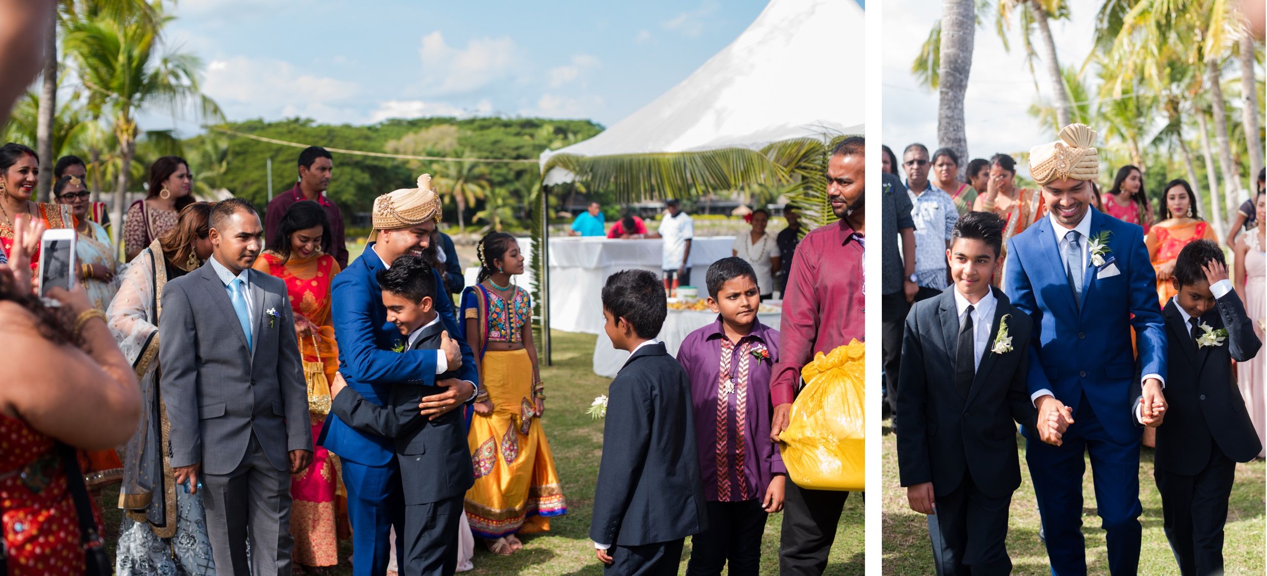 Wedding guests mingling under white tents with palm trees in the background.