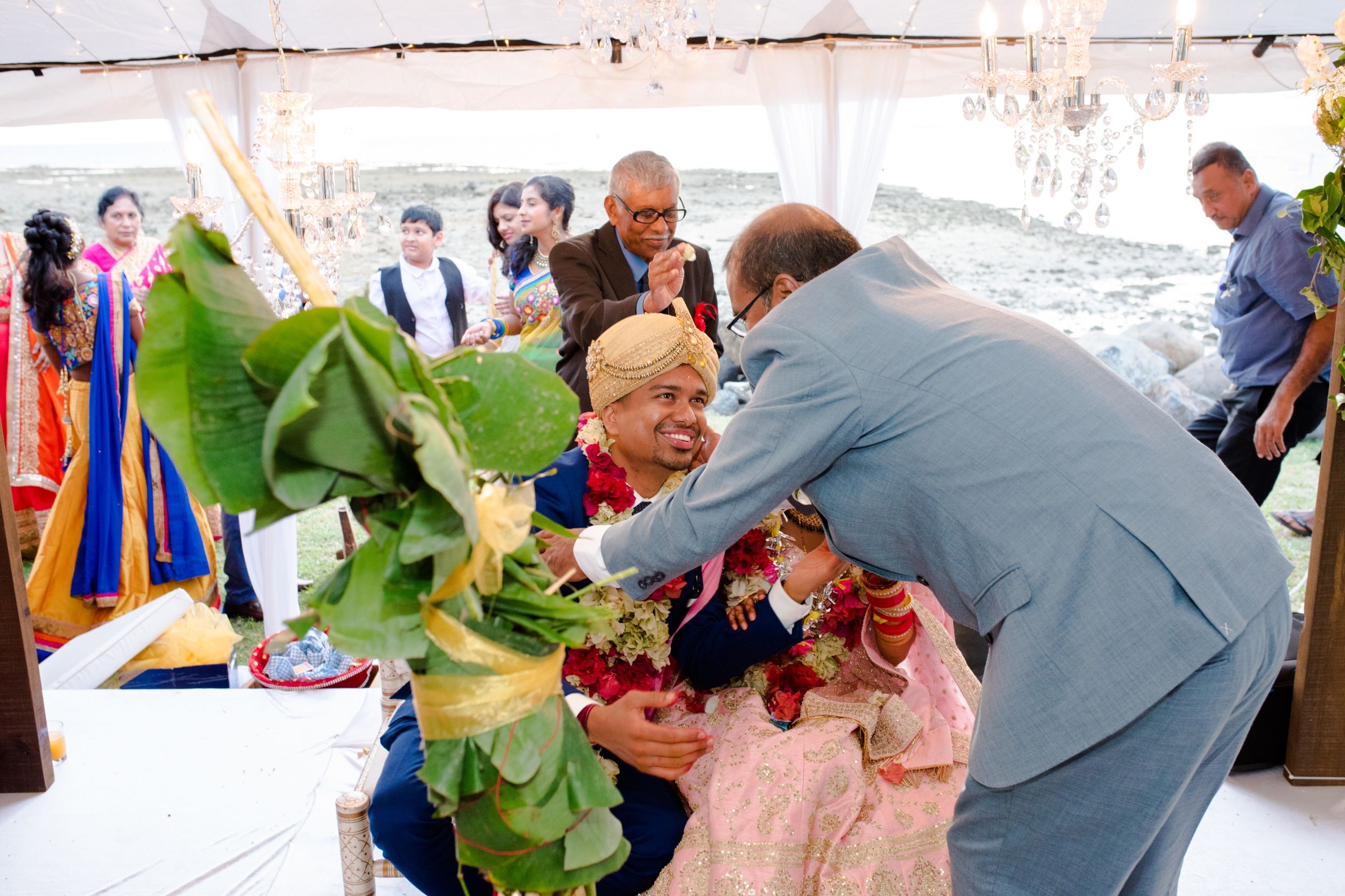 Wedding celebration scene with colorful decorations and guests interacting.