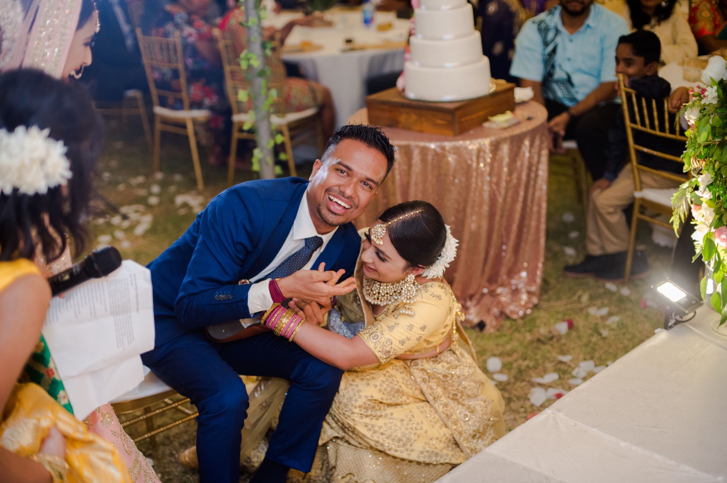 Joyful moment shared during wedding reception with festive decorations.