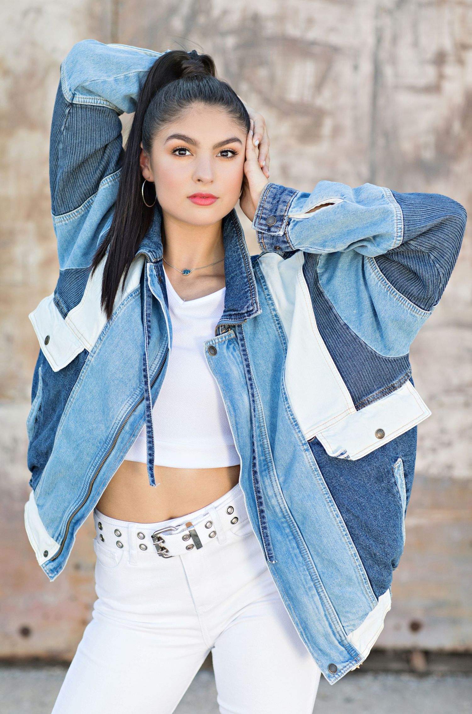 Street style fashion look featuring oversized patchwork denim jacket and white crop top.