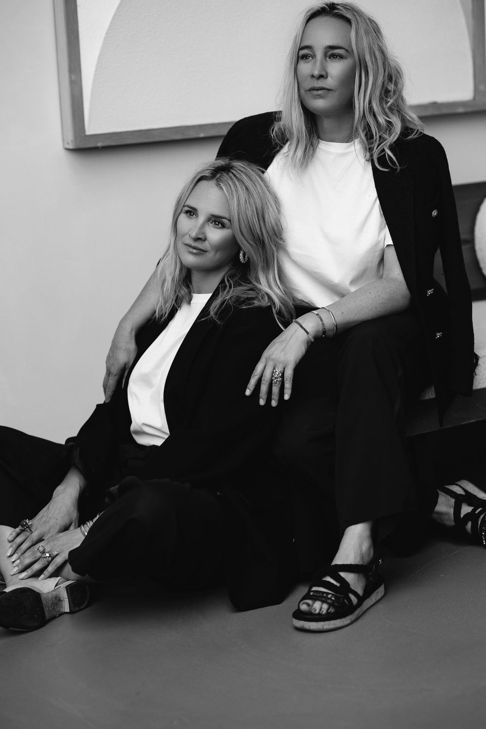 Black and white portrait of two people in contrasting black and white outfits.