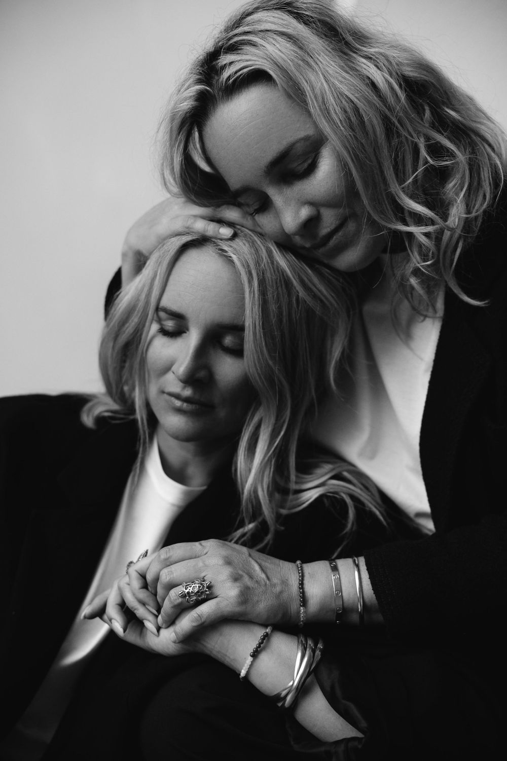 Intimate black and white photo showing tender moment between two women.