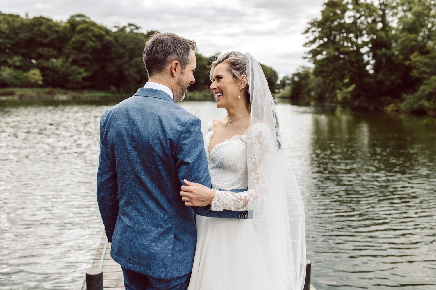 Romantic lakeside wedding portraits with scenic water views.