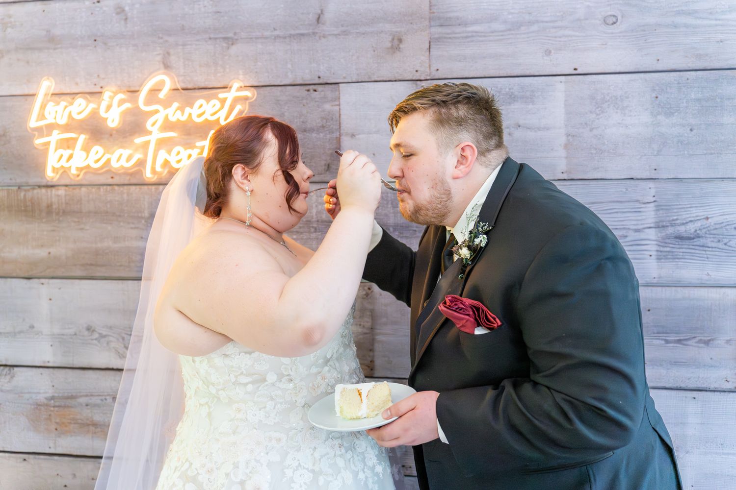 bride and groom feed each other cake