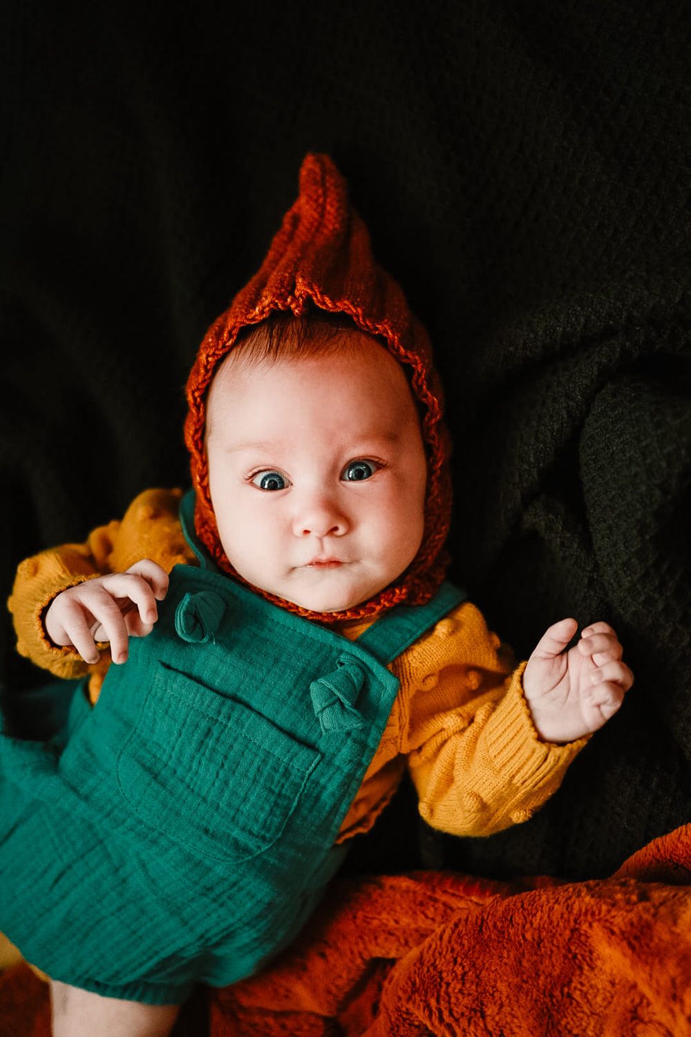 Adorable baby in colorful outfit at cozy in home session in Oak Ridge, TN.