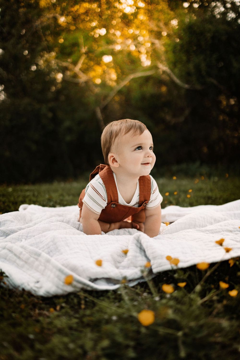 Baby smiling at mom at family session with beautiful golden light in Knoxville, TN.