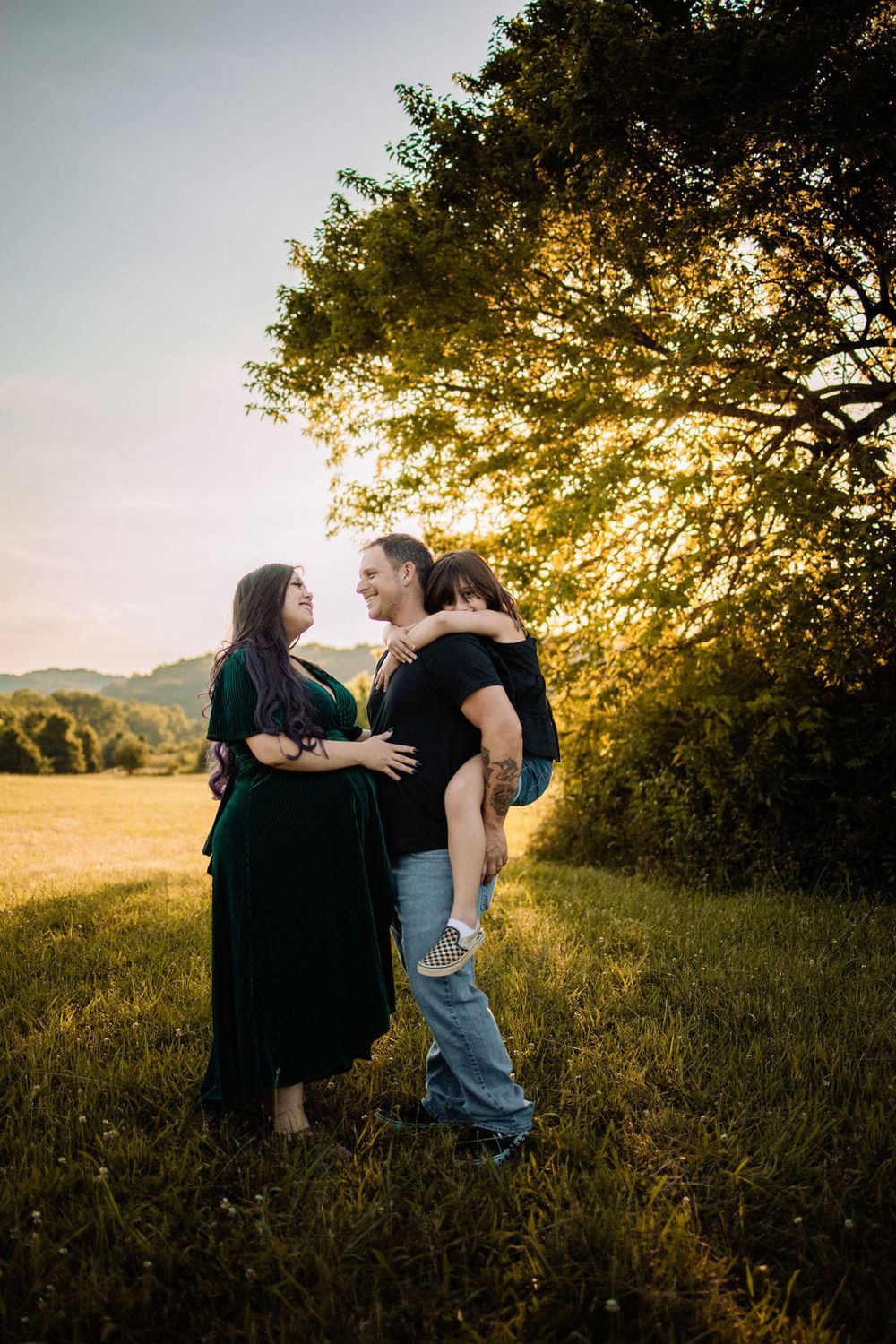A sweet family moment during a golden hour maternity session in Oak Ridge.