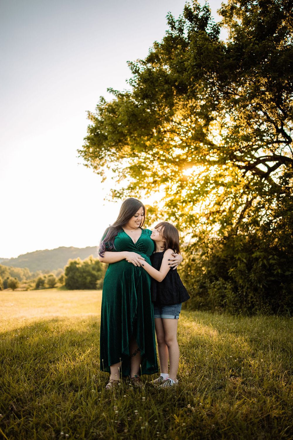 A special moment between a mother and daughter during an outdoor maternity session in Oak Ridge.