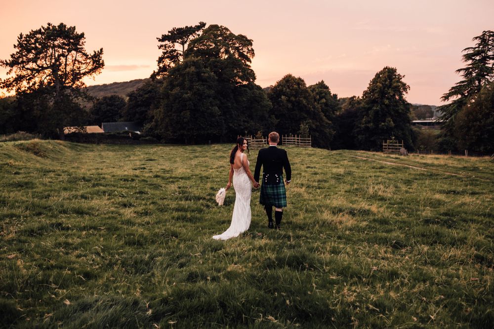 bride looking back over shoulder walking with groom