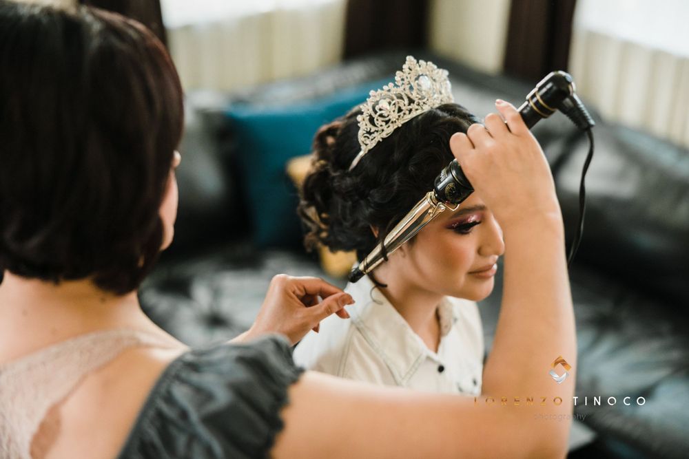 Styling session with crown and curling iron in preparation for formal event.