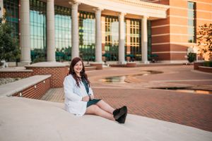 college graduate sitting on the stairs of Baylor university in Waco Texas