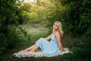 high school senior girl in light blue dress sitting in the woods mockingbird nature park midlothian Texas