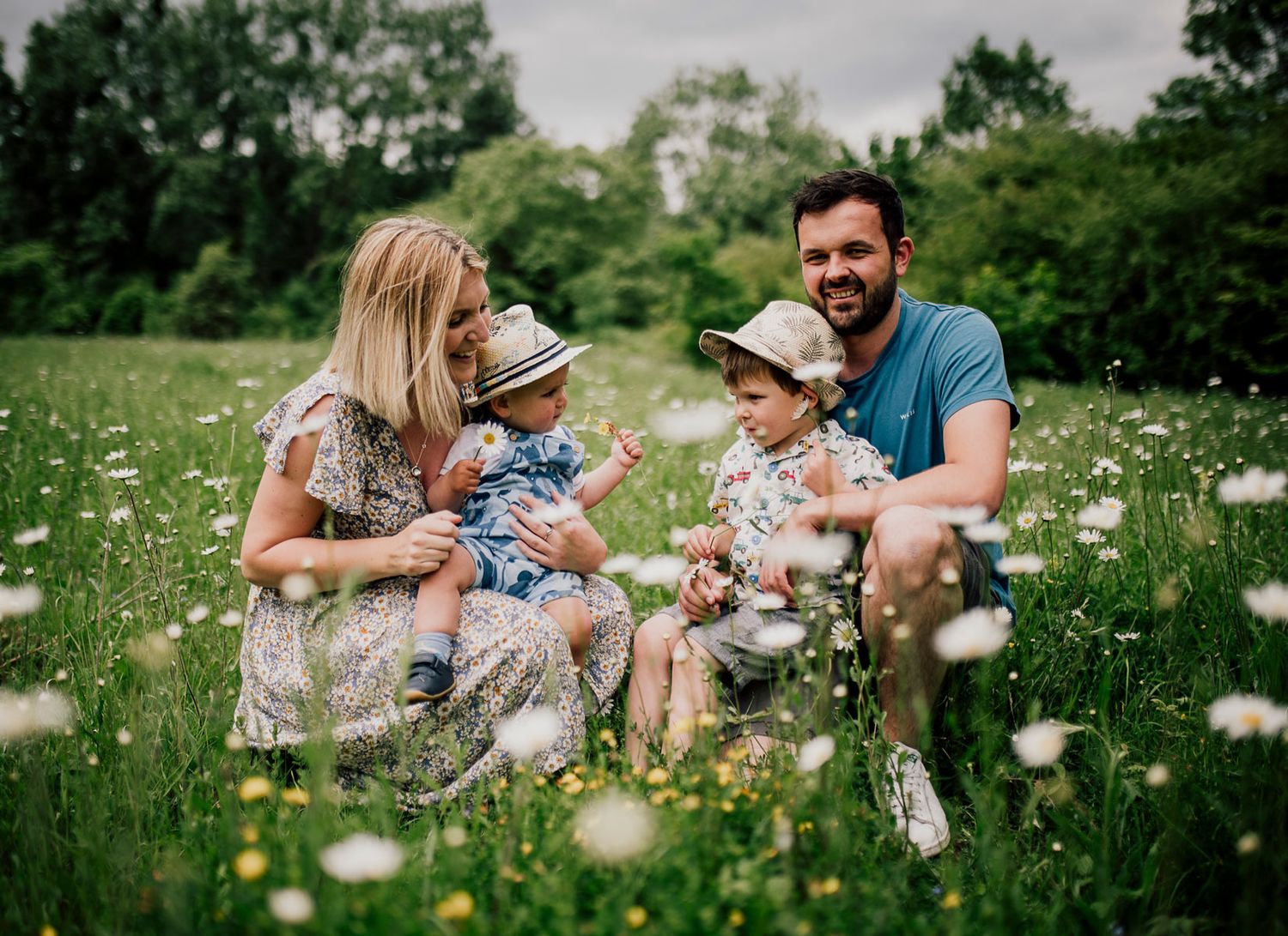 Family enjoying a summer day together in a blooming wildflower meadow. Worcestershire Wedding photographer.