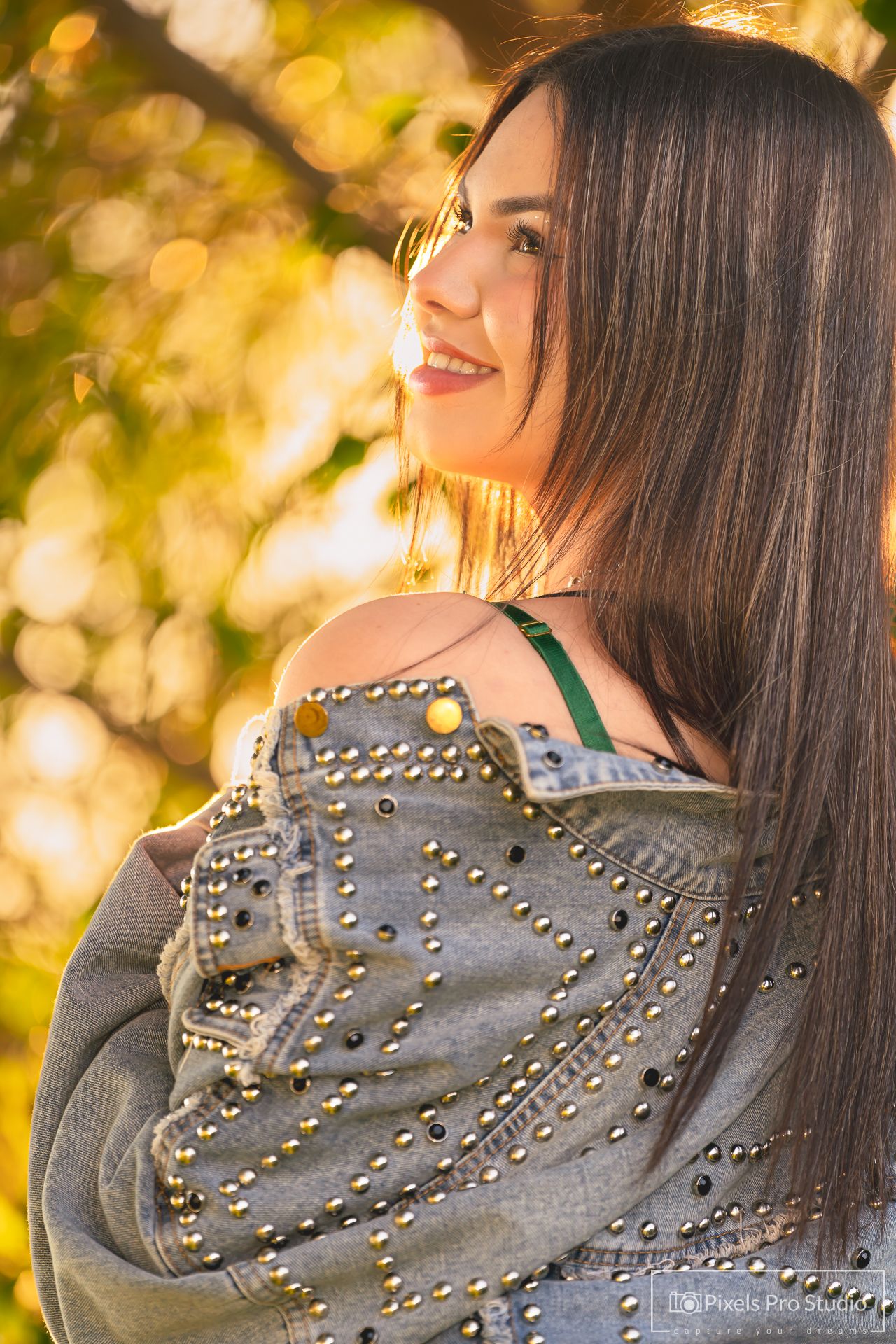 Close up of studded denim jacket with bokeh background.