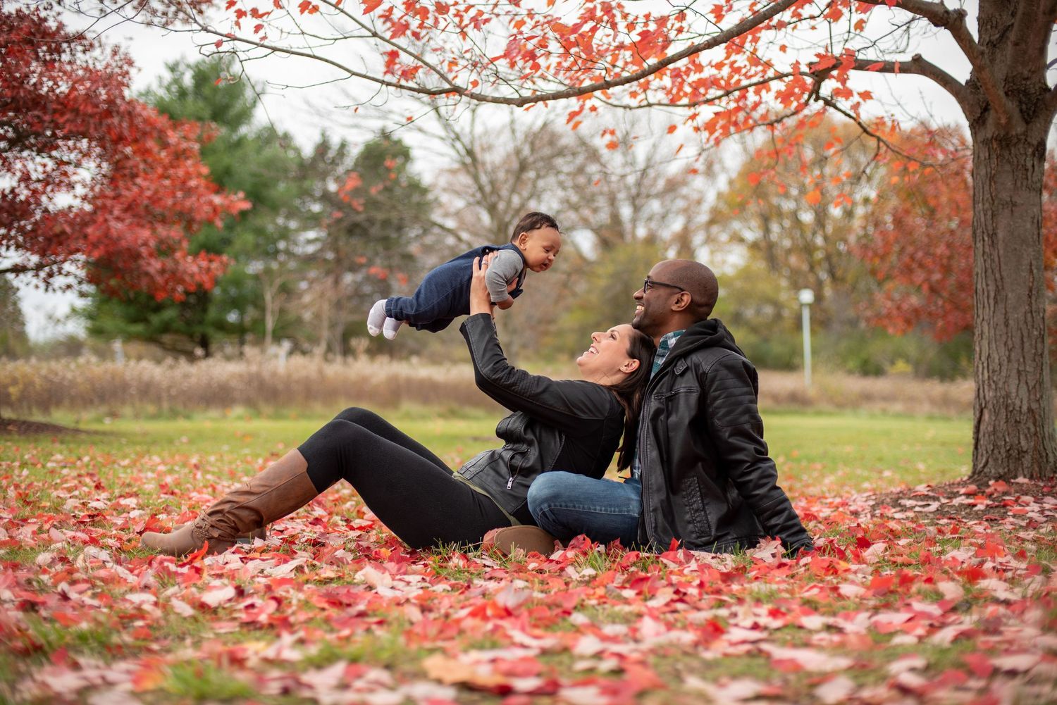 Family playing in the leaves