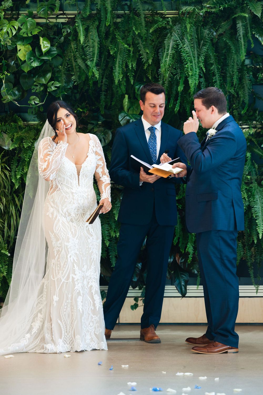Bride and grooms share sentimental moment during wedding ceremony at Jorgensen Farms in Westerville, Ohio.