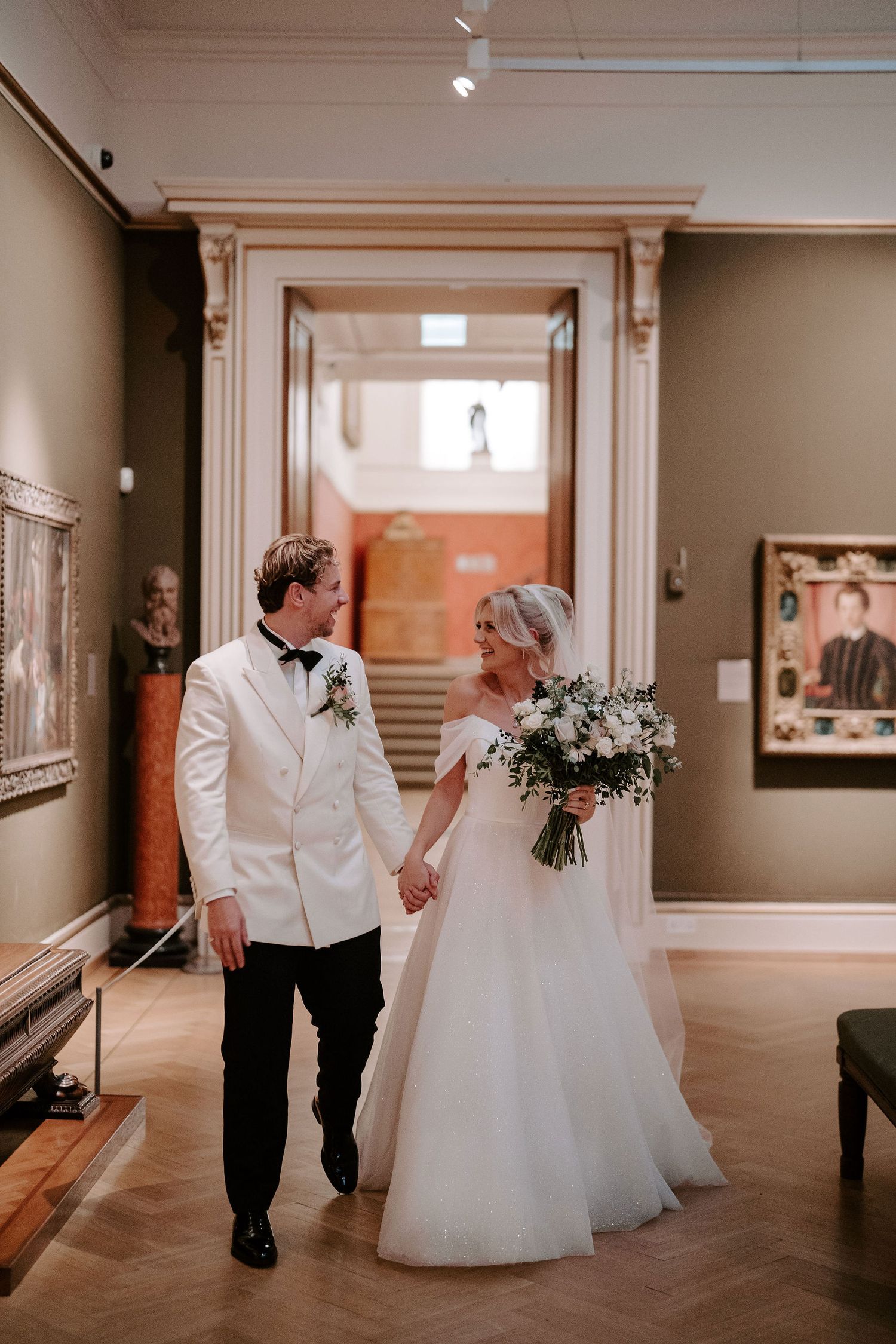bride and groom exiting ceremony as husband and wife in the European art gallery at the ashmolean museum