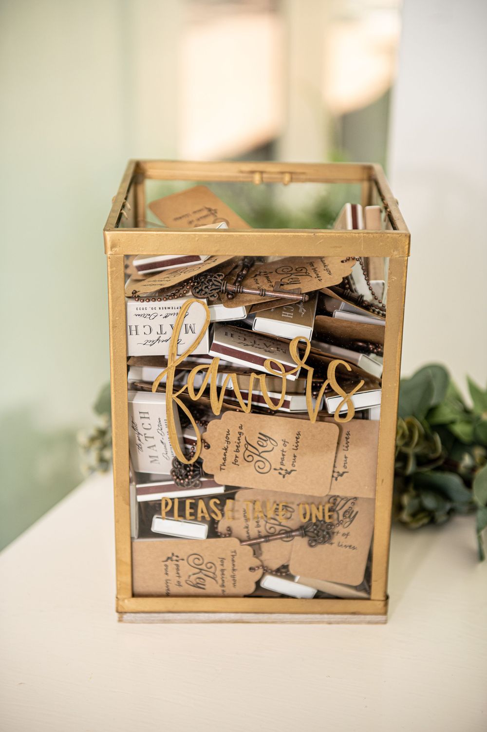 Vintage-style glass display box filled with wedding cards and messages.