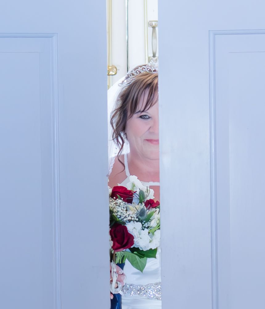 A series of white doors with glimpses of flowers visible through the gaps.