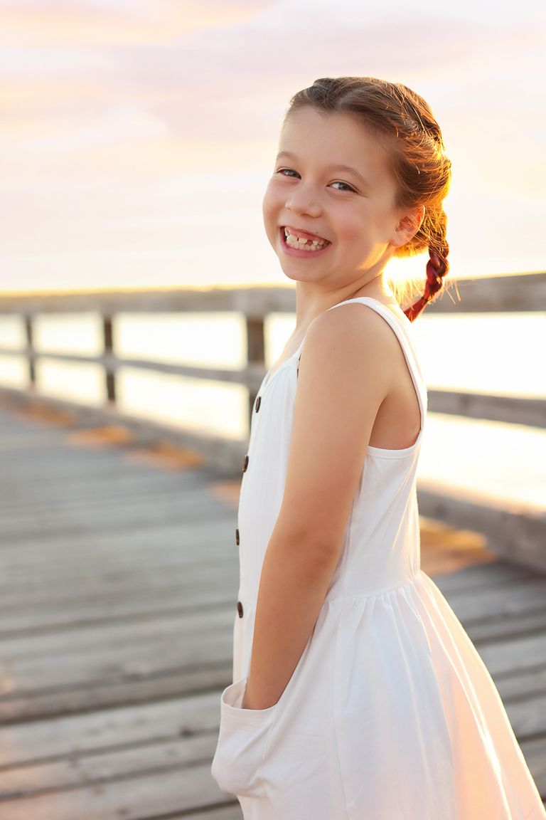 Kids photography, child photographer in Portsmouth New Hampshire.  Little girl on dock in the sunset