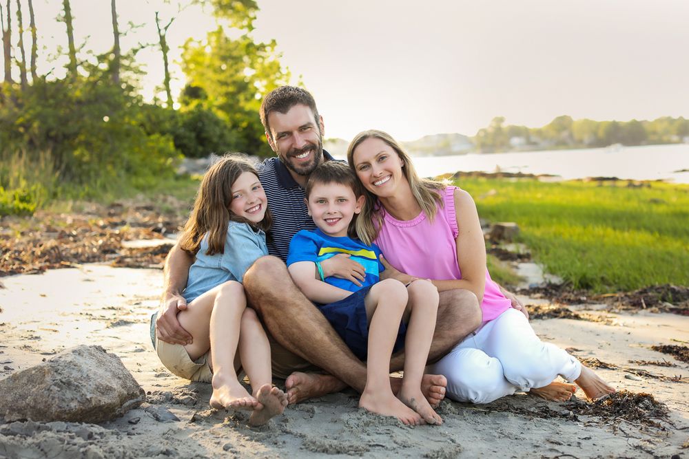 Kids photography, child photographer in Portsmouth New Hampshire. family sitting together cuddling and smiling