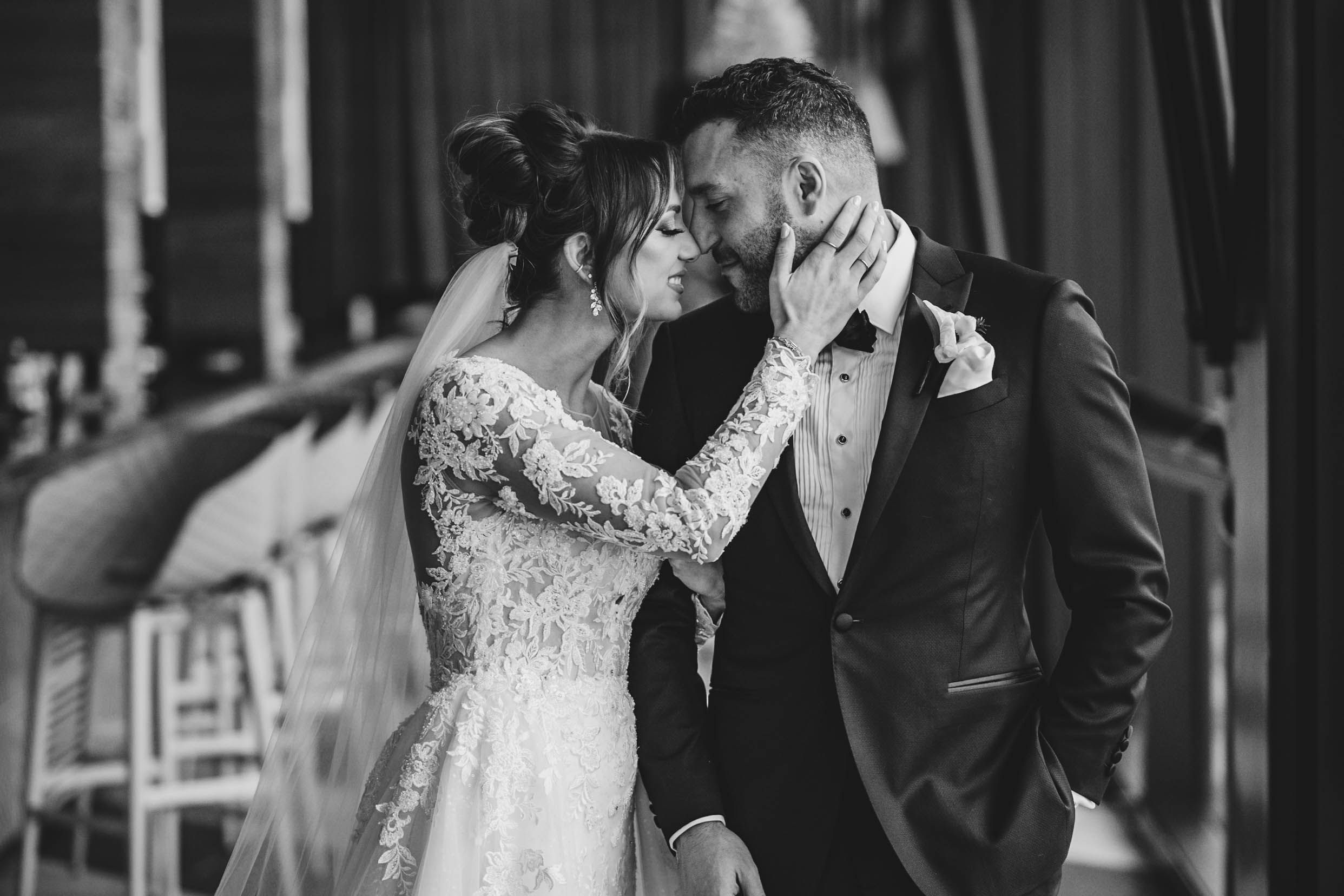 Black and white capture of wedding couple's intimate first look moment.