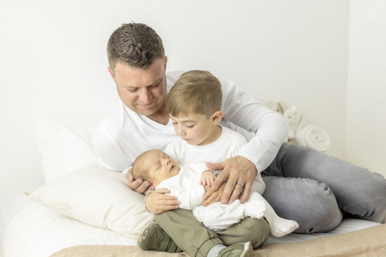 Father and children sharing a quiet moment during newborn family session in Centurion with natural, timeless style