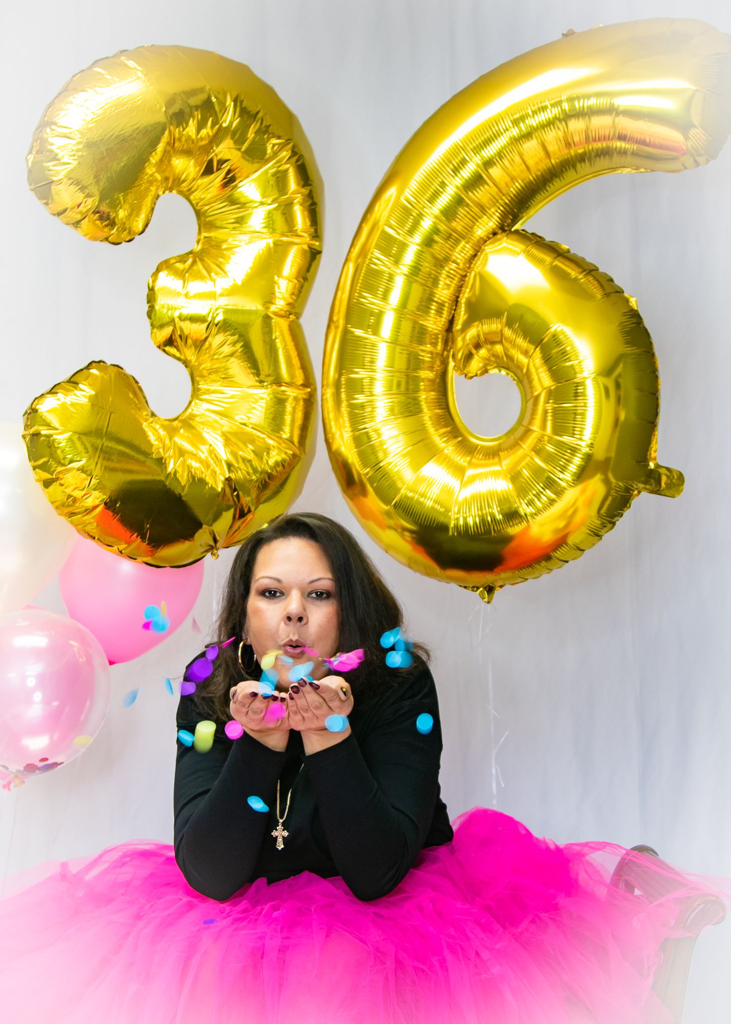 Birthday celebration with gold number 36 balloons and pink tulle skirt.