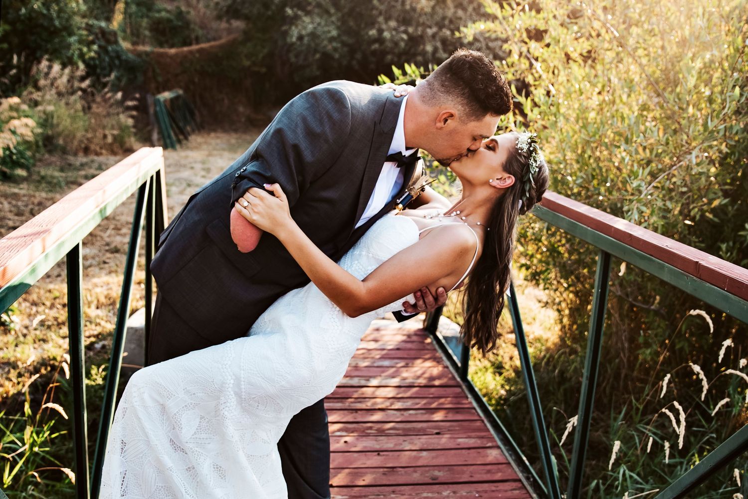 Groom dips bride during bridal portrait session in Pocatello, Idaho orchard.
