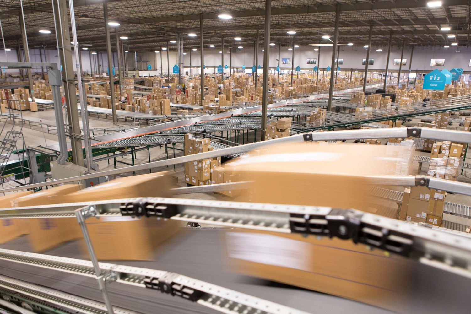 Large warehouse interior with conveyor belts and automated packaging equipment.