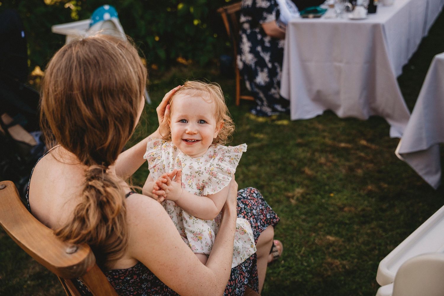 Joyful moments shared between guests during a sunny outdoor celebration.