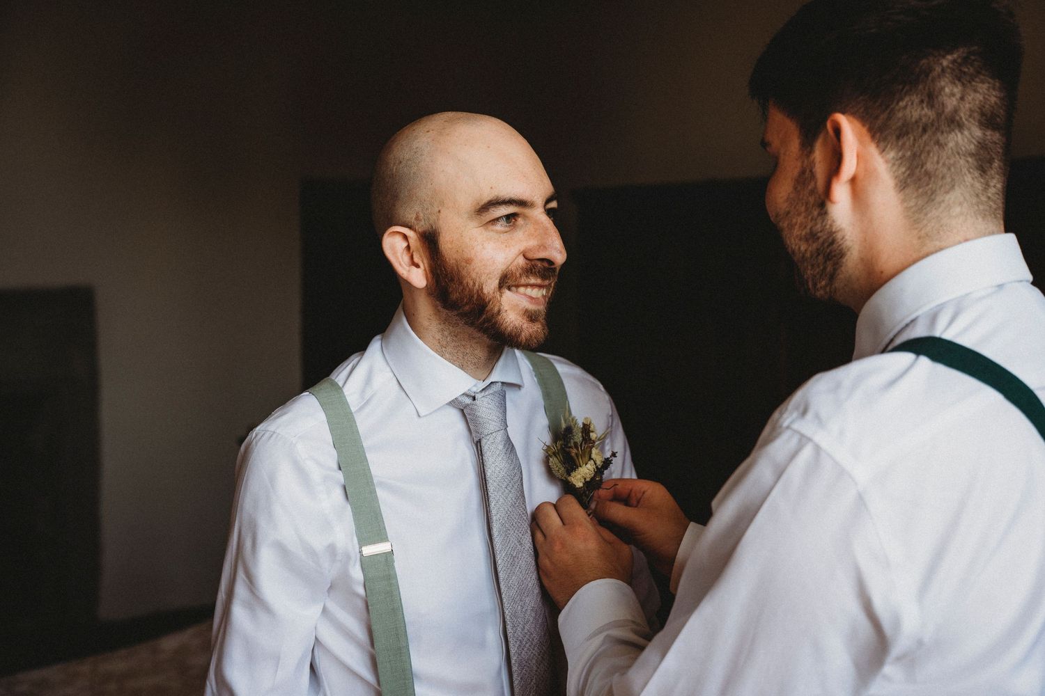 Person in white shirt and tie preparing for formal event.