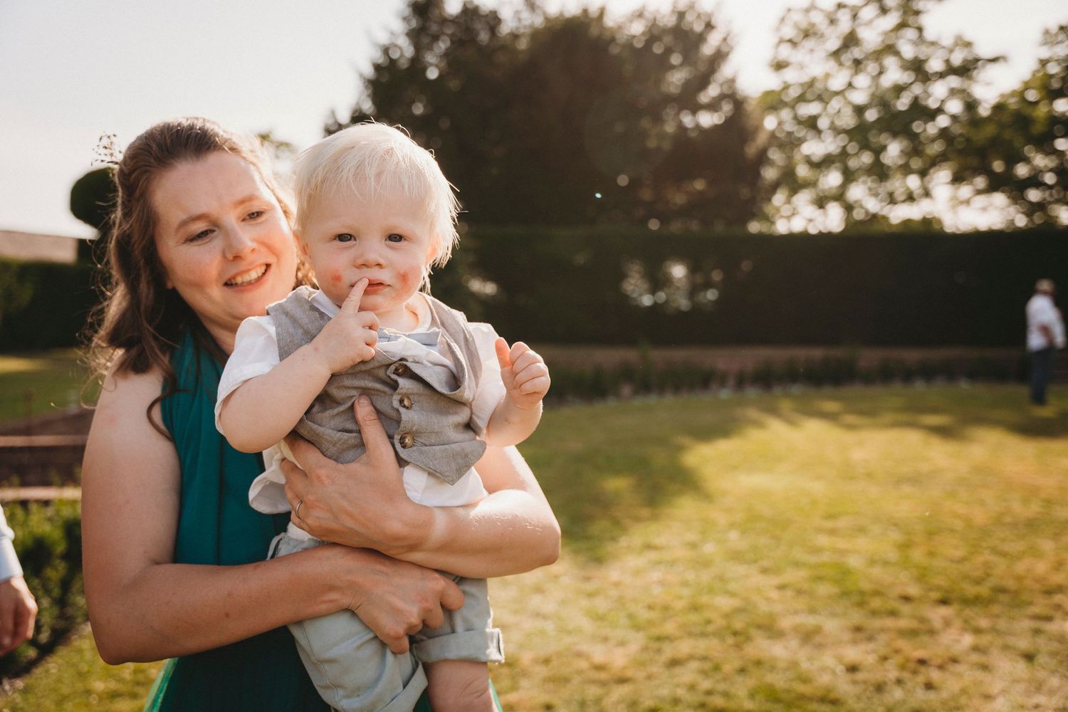 Tender moments captured during golden hour at an outdoor celebration.