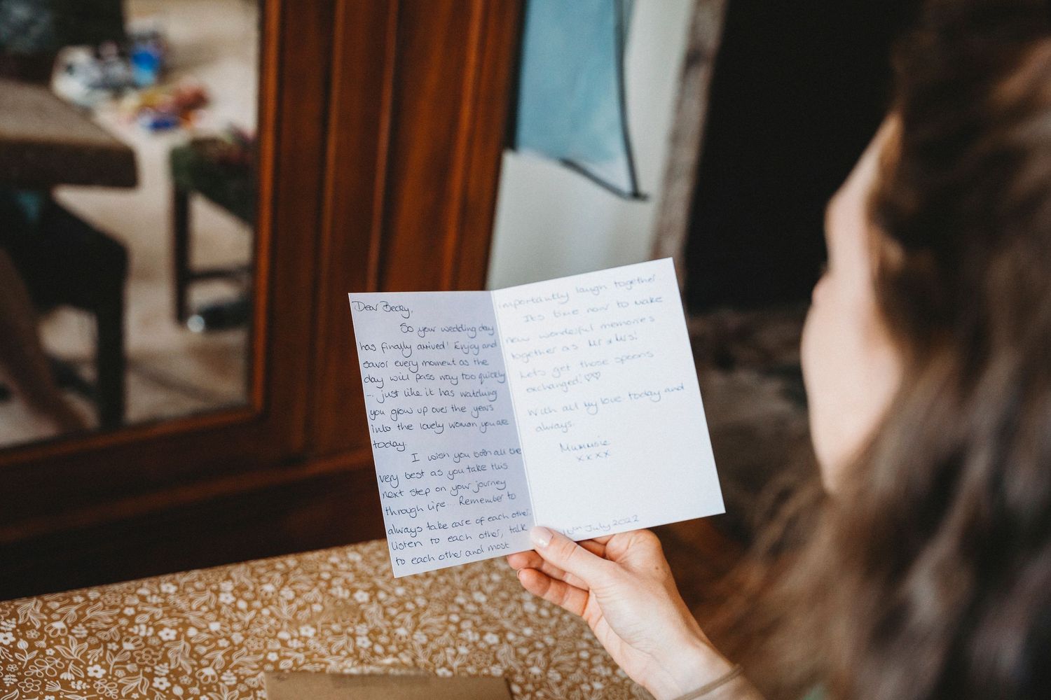A handwritten note being read in natural lighting.