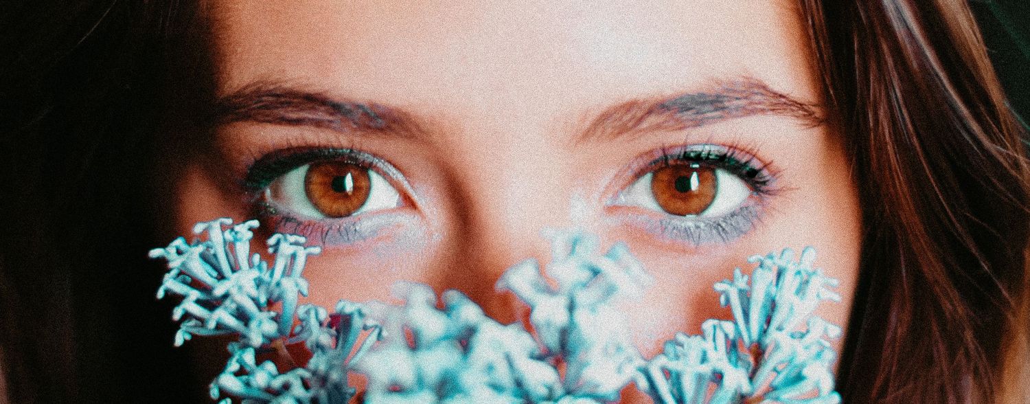 Close-up portrait shots showing vibrant blue flowers and soft natural lighting.