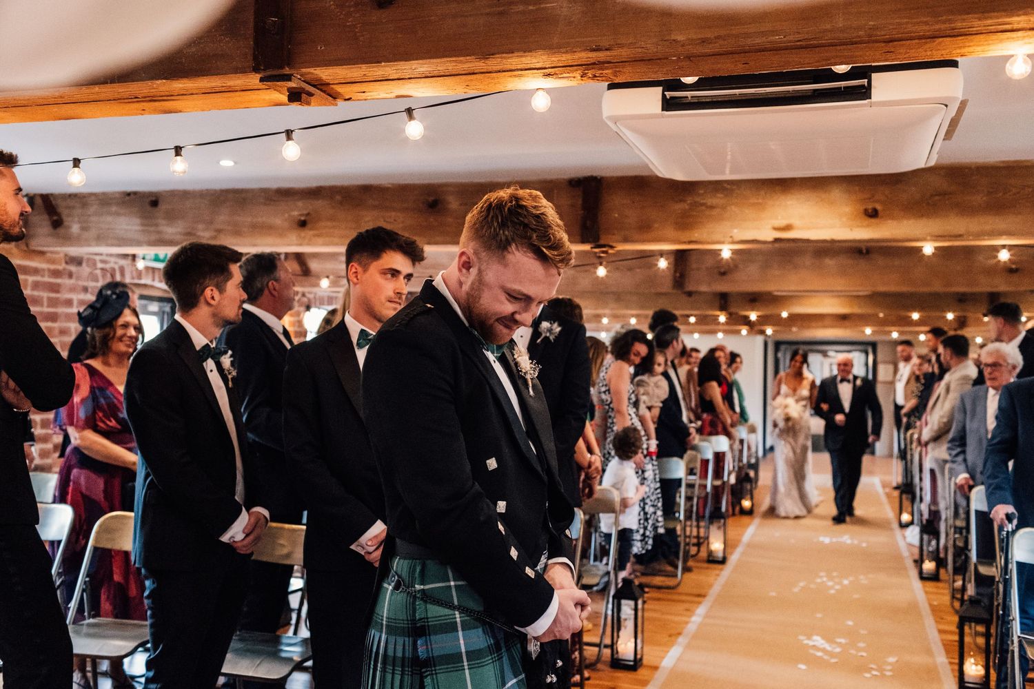 groom waiting at the aisle for his bride