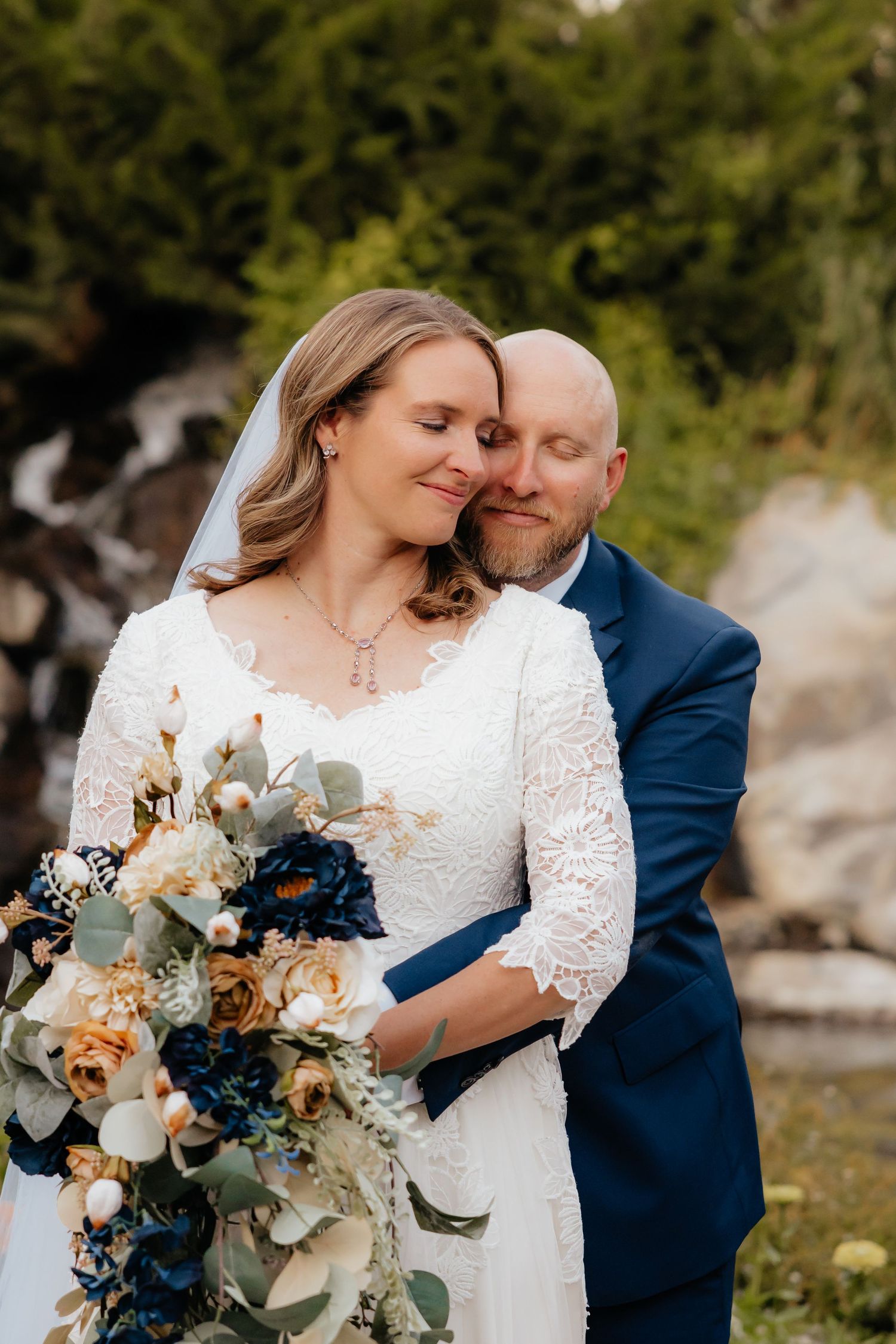 Groom hugging bride from behind at Thanksgiving Point Gardens in Lehi, Utah