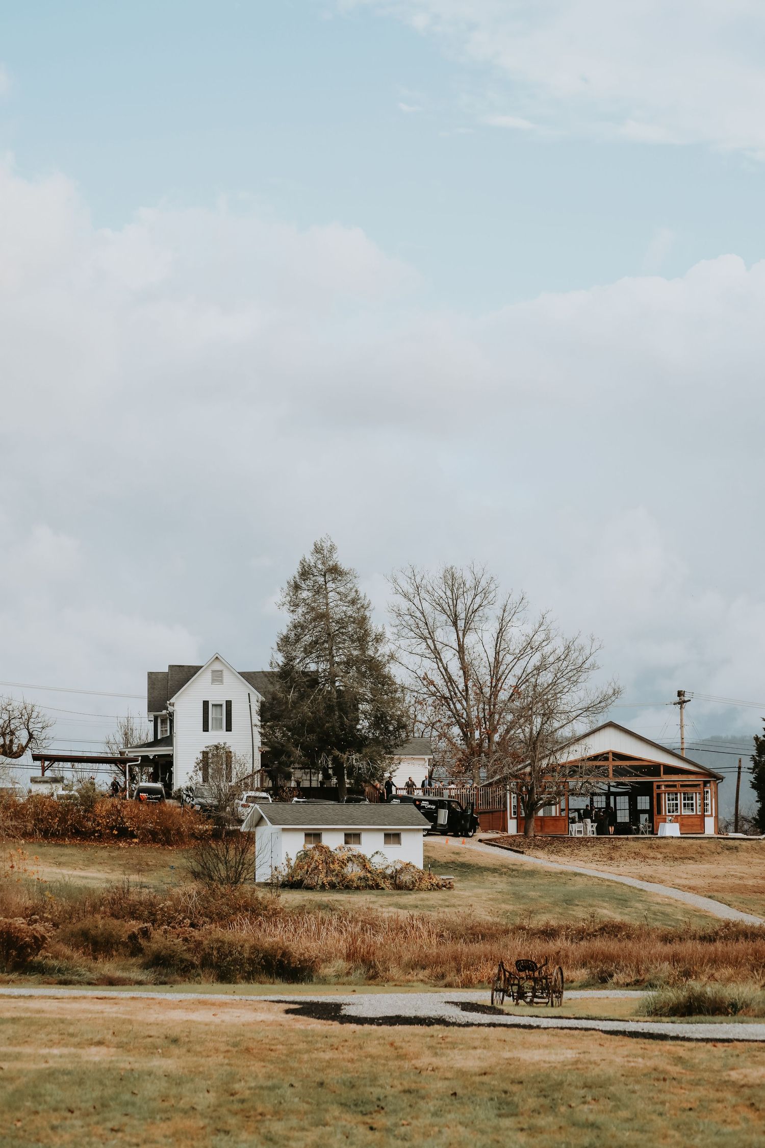 Rural landscape with scattered white houses and buildings in an open field.