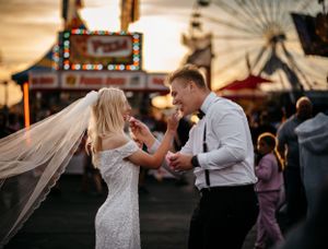 A couple share food at the Erie county fair on their wedding day photography buffalo new york