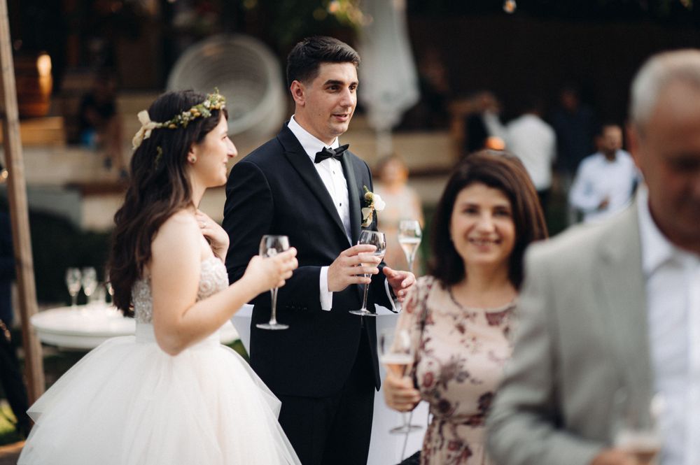 A celebratory toast at an outdoor wedding reception.