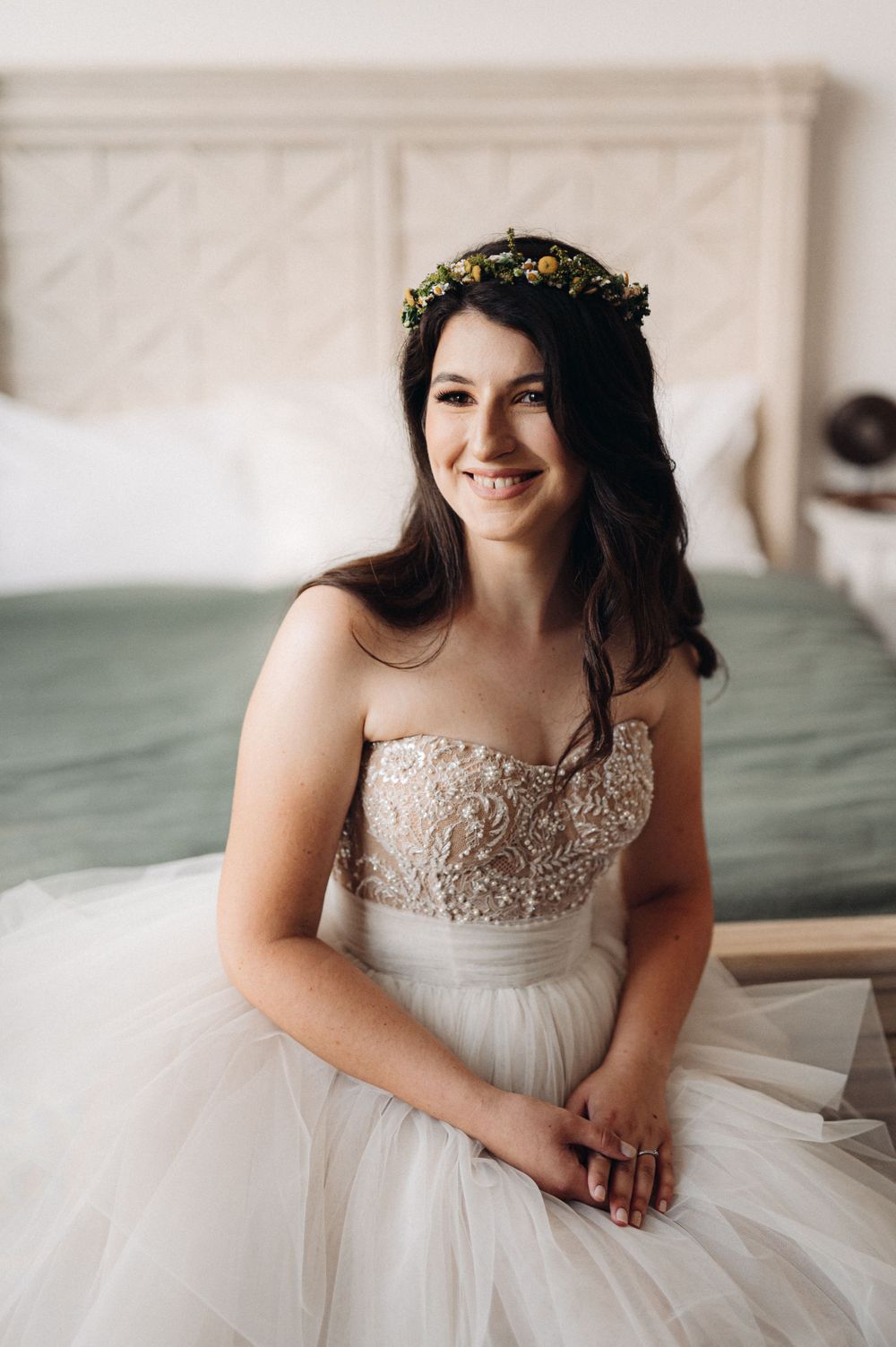 Beautiful bridal portrait featuring a delicate floral crown and strapless beaded wedding gown.