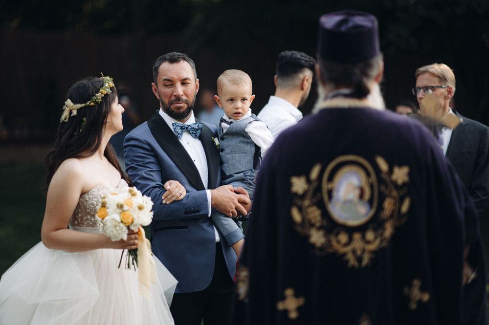 Outdoor wedding ceremony gathering with guests in formal attire.