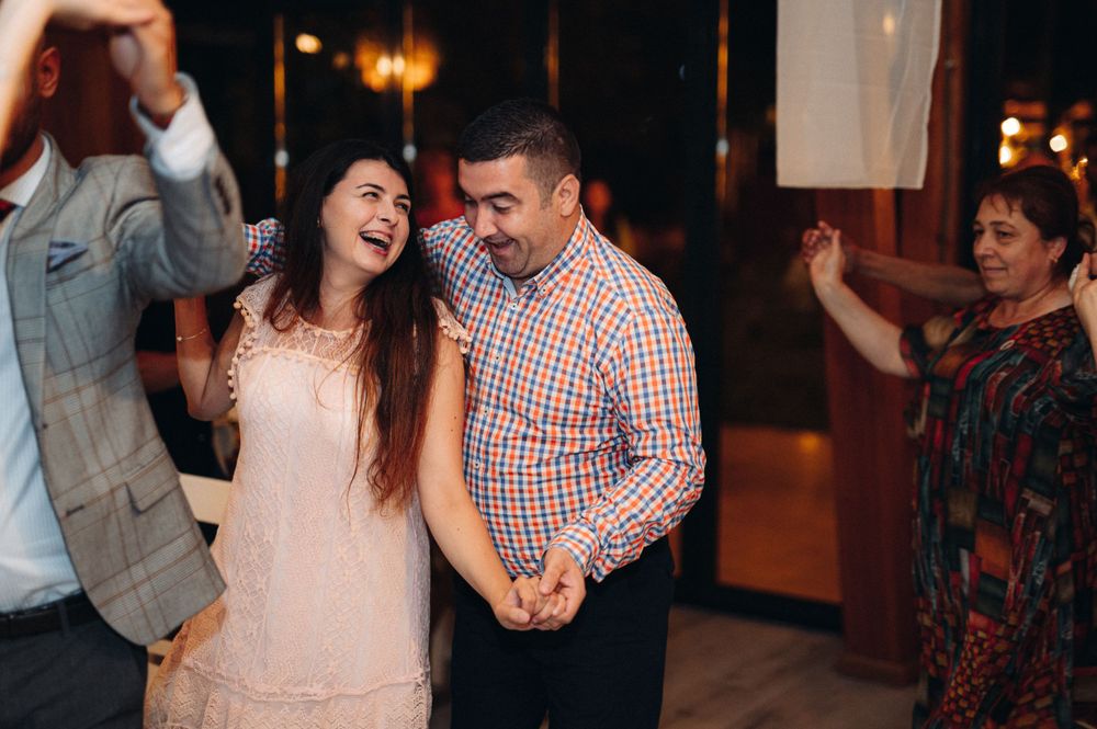Happy guests share joyful moments during a wedding reception celebration.