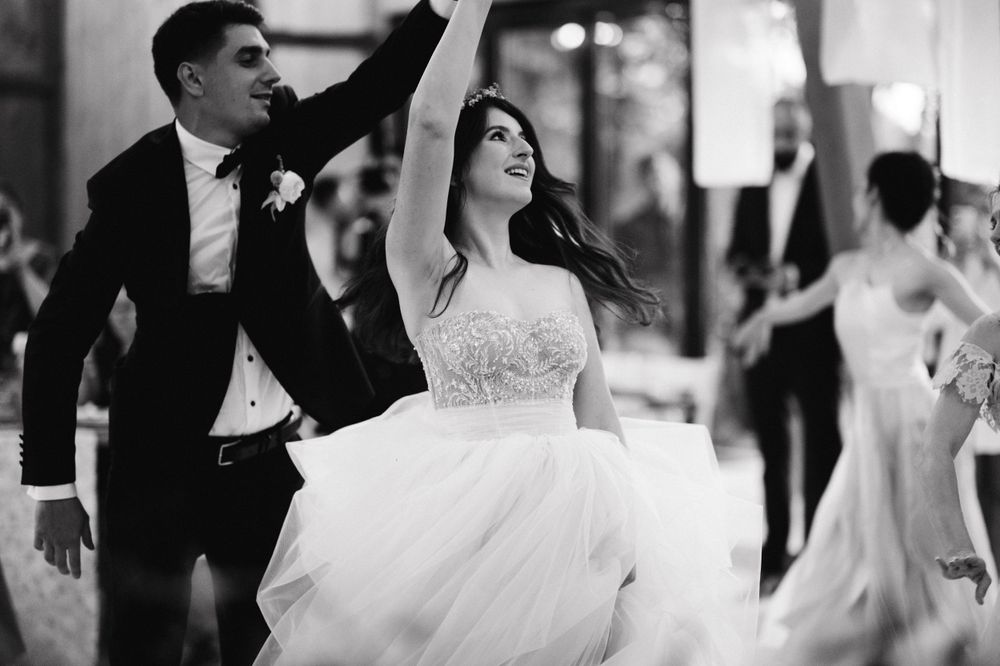 Dynamic dance moment captured in black and white at elegant wedding reception.