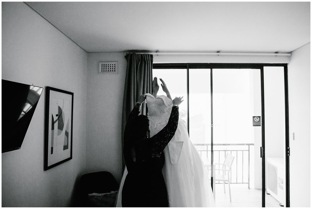 bride putting her dress on