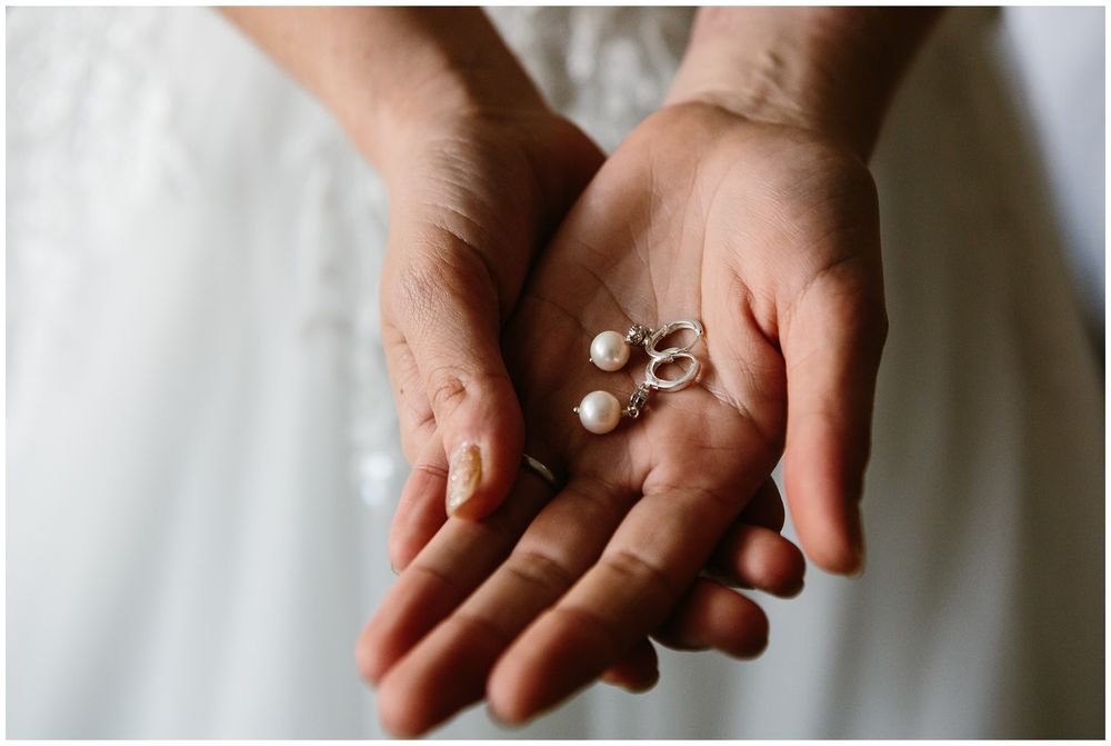 bride holding her earrings