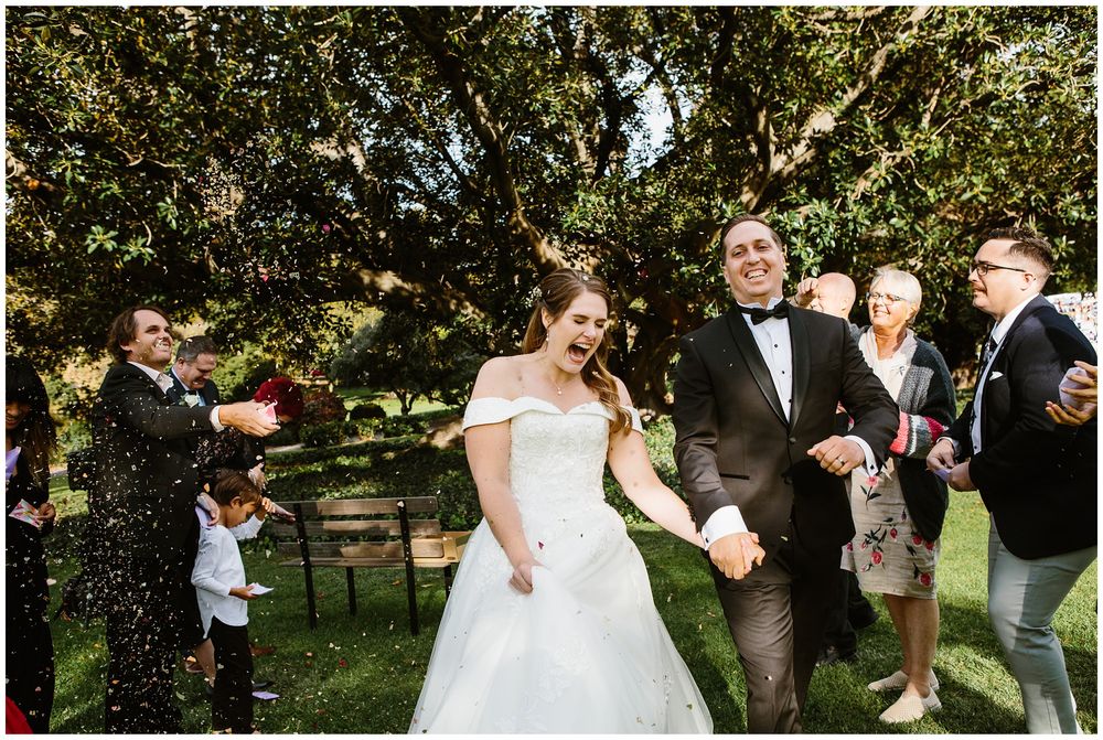 hyde park wedding bride and groom walking down the isle under confetti