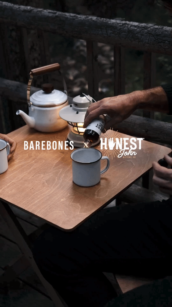 Barebones and Honest John Bitters collab video of people having a drink in a wooded cabin setting in the Utah mountains.