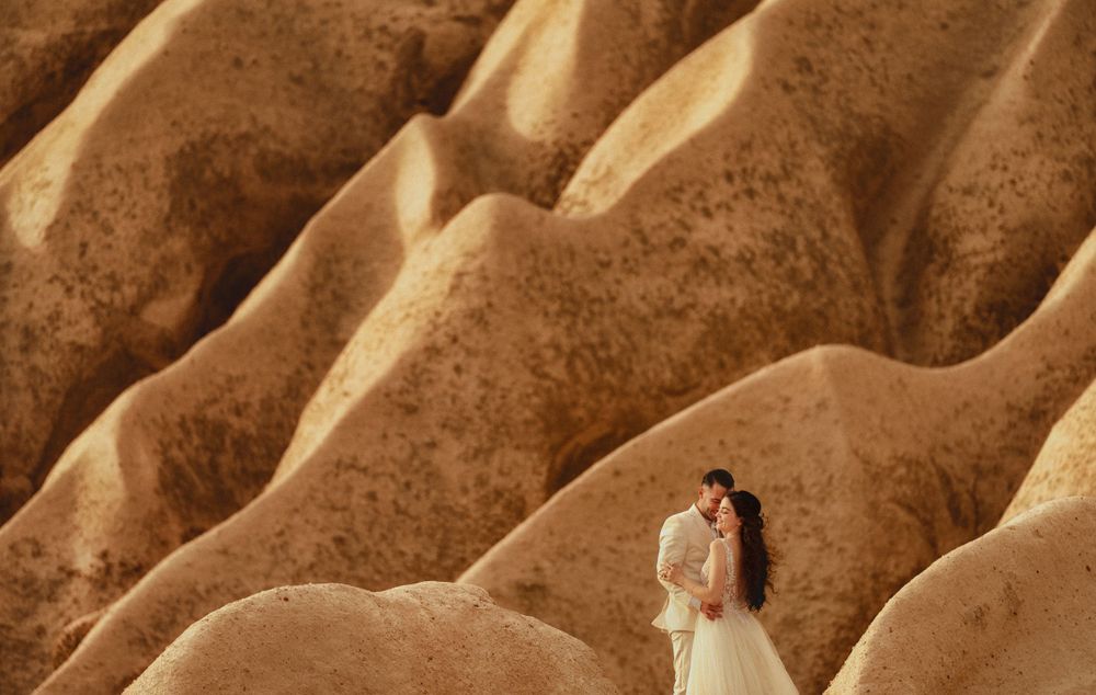 Textured beige rock formations creating abstract patterns in natural sunlight.