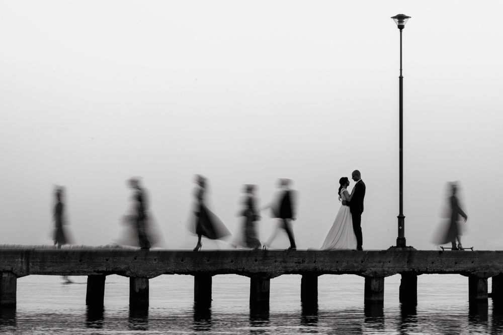 Minimalist silhouettes of people walking along a misty horizon line.